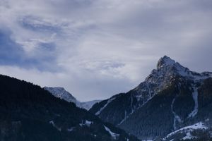 Snowy mountain where the peak is lit by sunlight